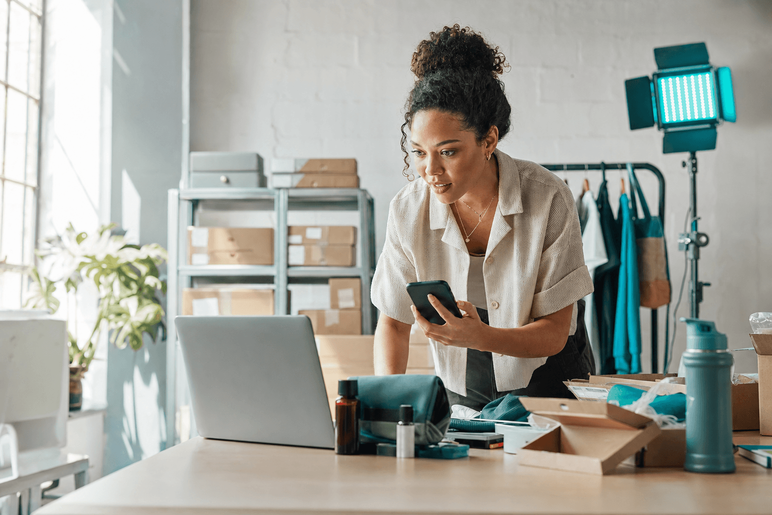 Young ecommerce operator responding to a product signal in her studio